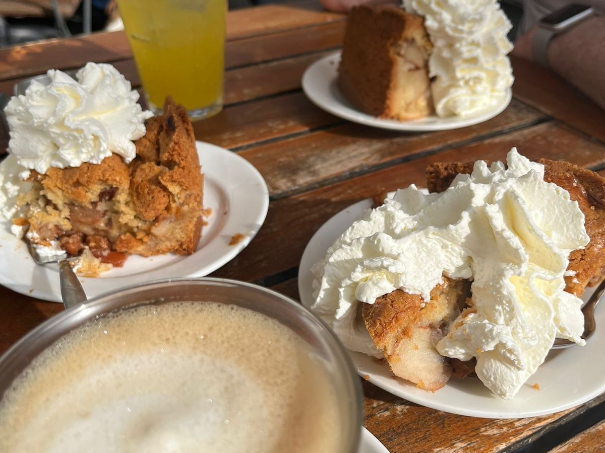 Three apple pies with whipped and a latte. One of the best desserts in Amsterdam