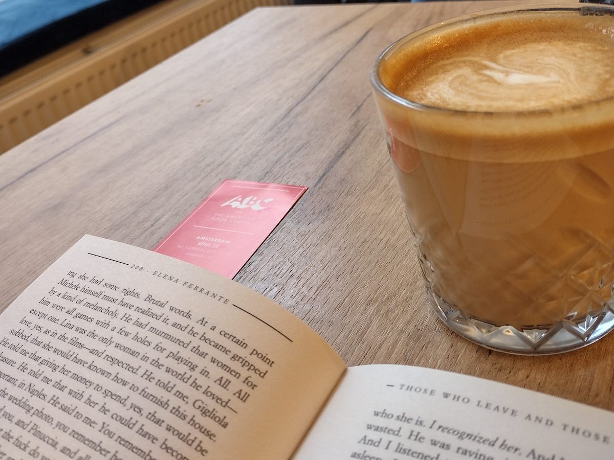 Liev coffee in Amsterdam with an open book