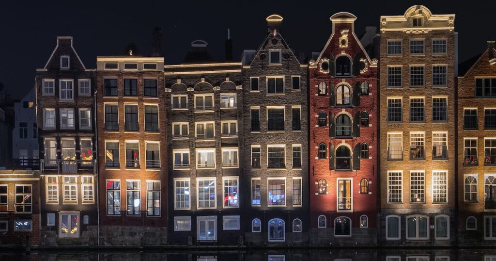 Amsterdam Canal at night. Houses lit up