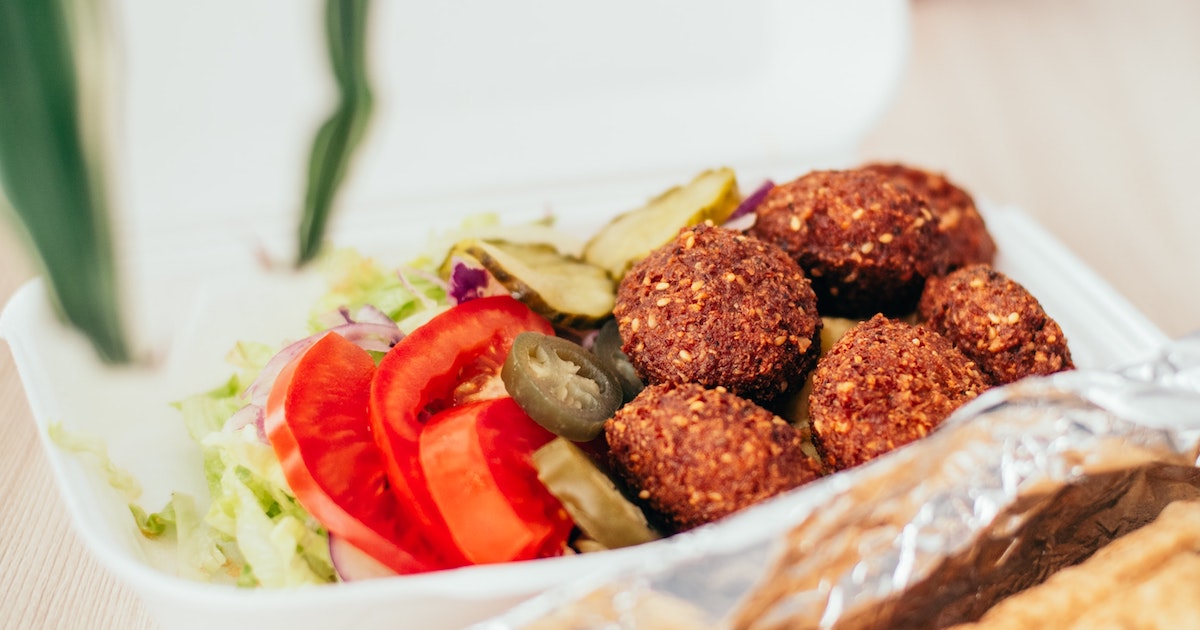 A bowl of falafel with salad on the side