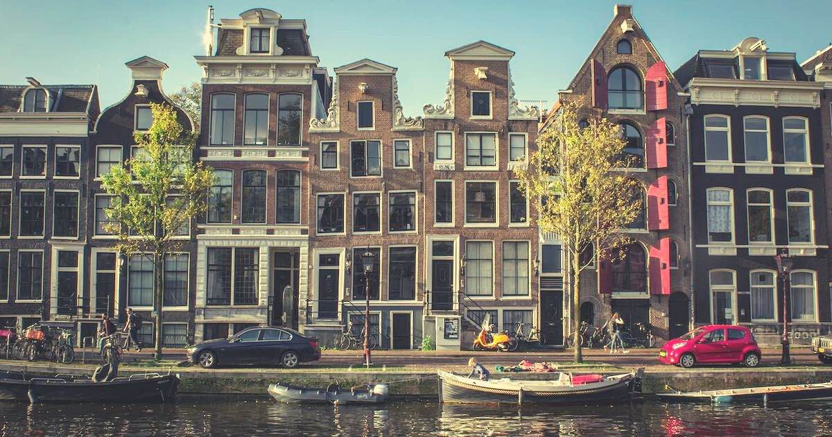 houses along the canal in Amsterdam. The Vegetarian Food Guide to Amsterdam