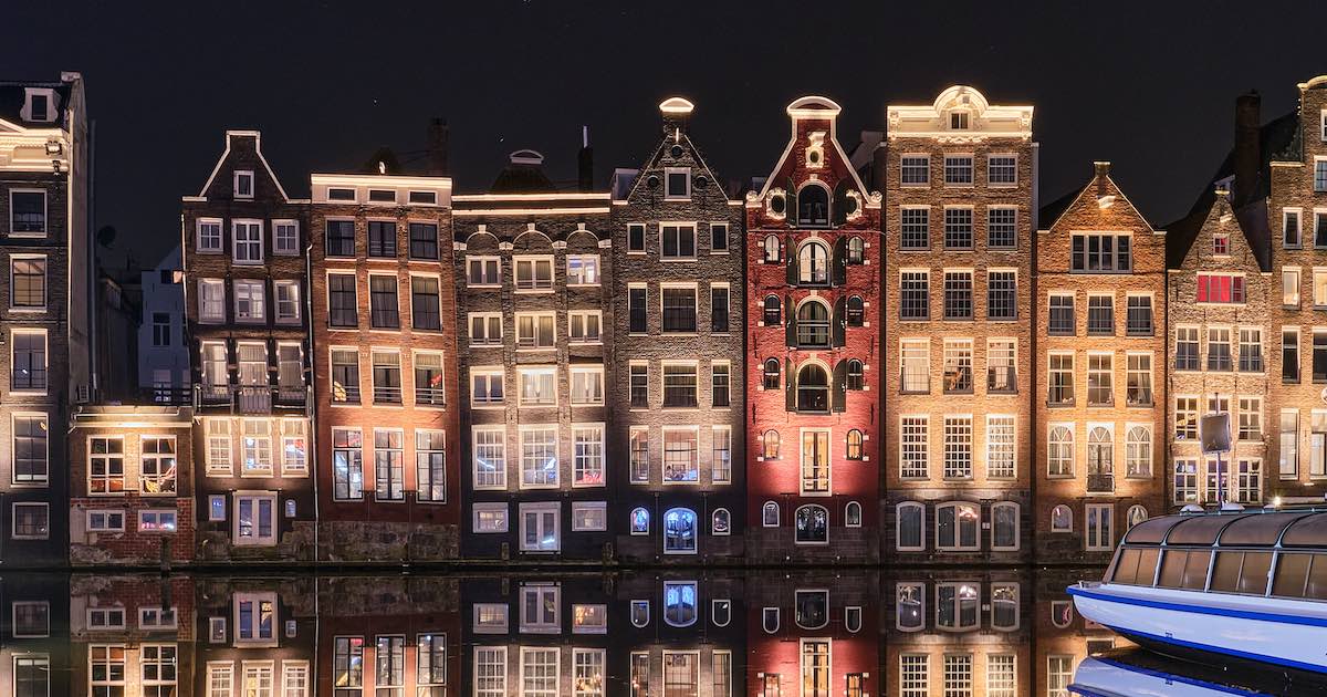 canal houses lit up at night