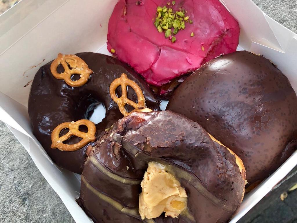 close up of four donuts