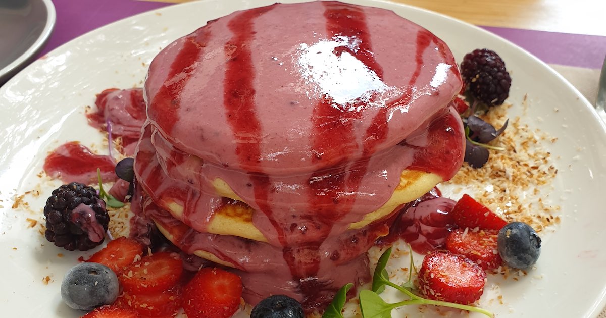 Lato Cafe Pancakes covered in berry and yoghurt coulis with lots of fruits