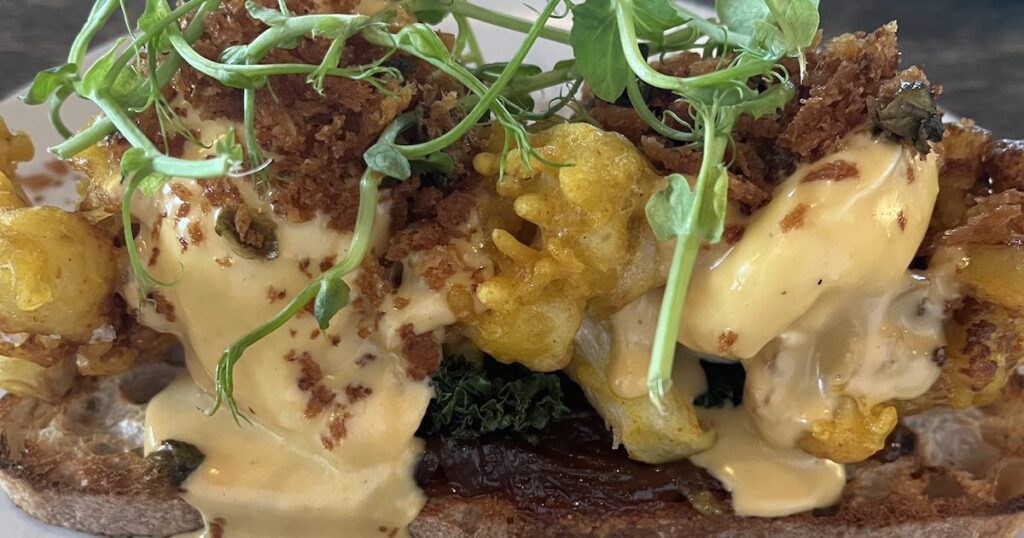 an eggs benedict at lunch in Belfast spot Estabhlised coffee. With crispy cauliflower