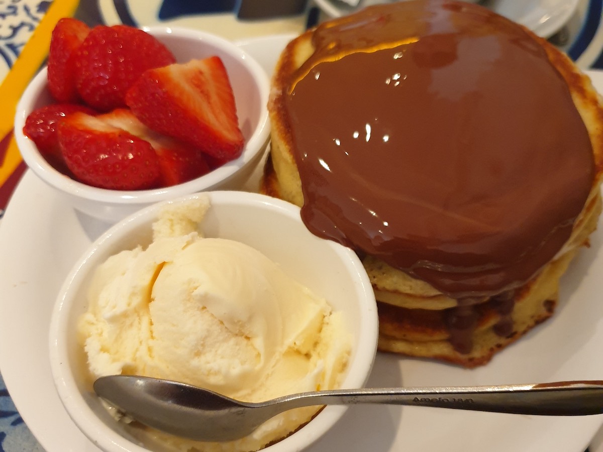 american style pancakes covered in chocolate sauce with strawberries at PANCAKES in Amsterdam