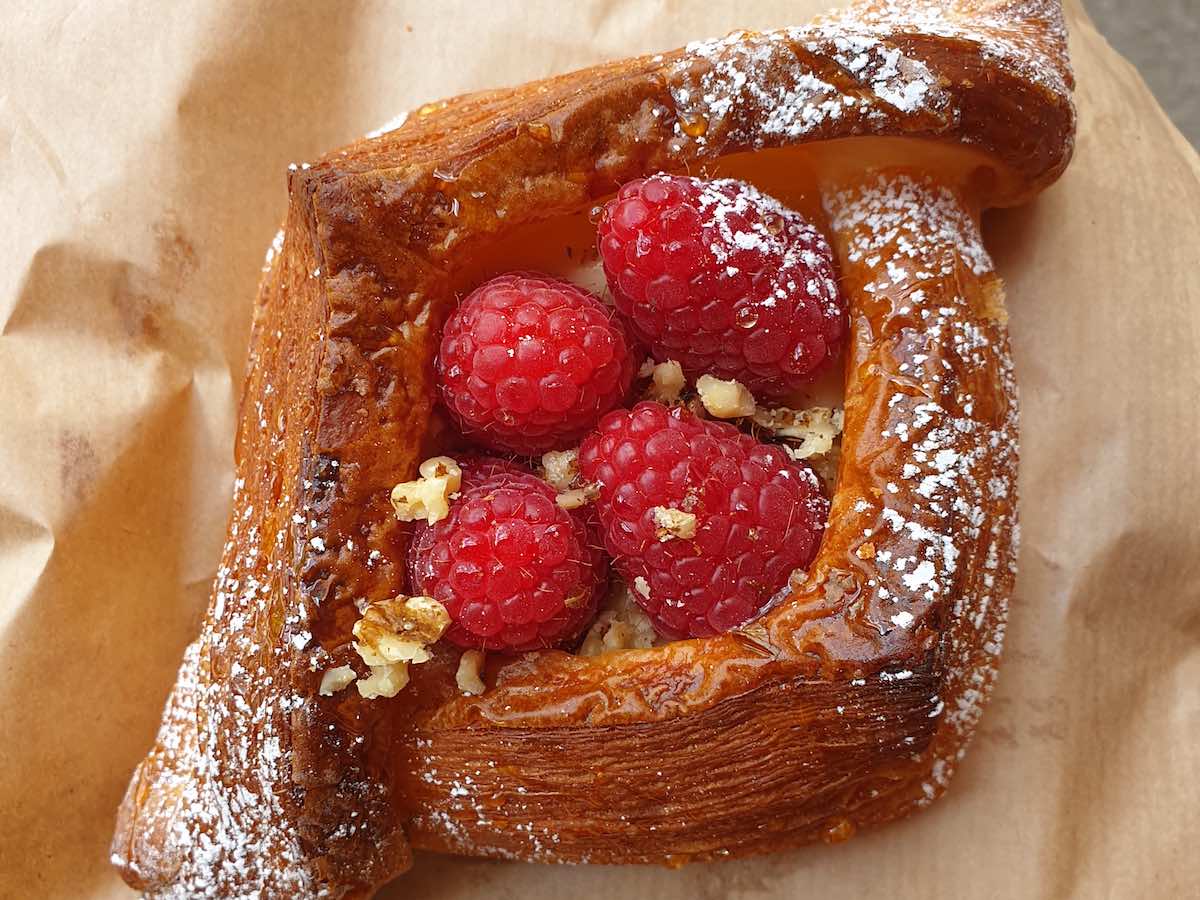 a pastry with fresh raspberries at pophams